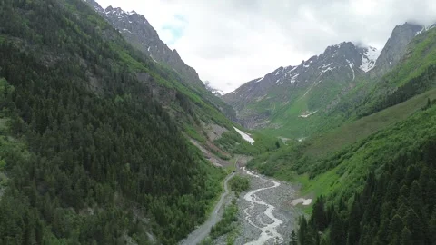 Drone footage flying backward over the Tekhuri river gorge, wide panoramic r Stock Footage 343863397