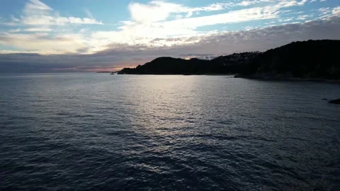 Drone footage flying backwards over the sea near the rocks Stock Footage 227009470