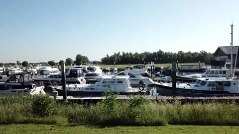Drone footage of flying by a full pier of luxury yachts. Stock Footage 158996063