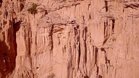 Drone footage flying over rugged red rock terrain in New Mexico Видео 334765607