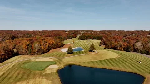Drone footage of a golf course set against a picturesque landscape, complete wit Stock Footage 289593492