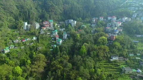 Drone footage highlighting the layered, vibrant houses of Gangtok. 動画素材 311370551