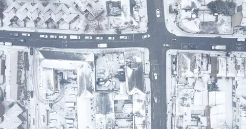 Drone footage hovering of an intersection on a snowy day in London England. Stock Footage 87168414