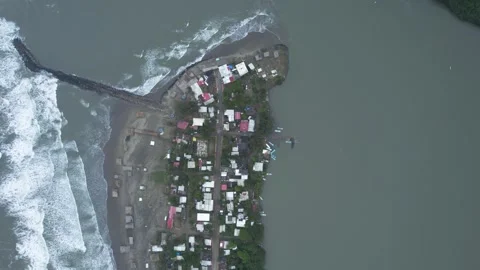 Drone footage in jib up with view of function of breakwater and waves Stock Footage 242426373