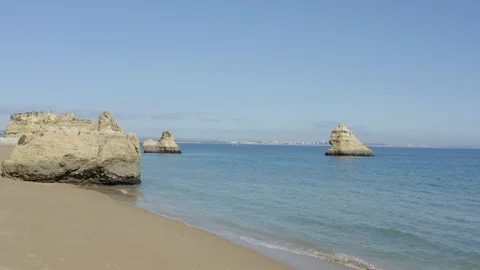 Drone Footage Of Large Empty Sandy Beach With Small Rocks Islands Stock Footage 128838662