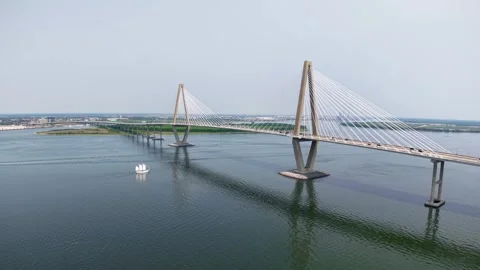 Drone footage of a long cable stayed bridge spanning a wide river in Charleston Stock Footage 327436568