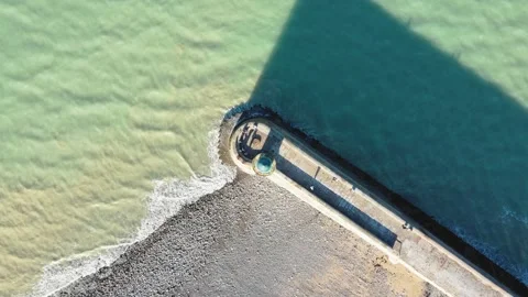 Drone footage looking directly down at the pier and breakwater of Saint-Valery Stock Footage 346670300