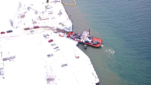 Drone footage looking down on a ferry route serving Sugar Island residents and Stockbeeldmateriaal 335299157