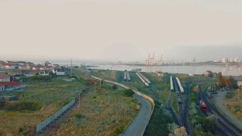 Drone footage of man riding bicycle near the sea port in twilight Video stock 84934403