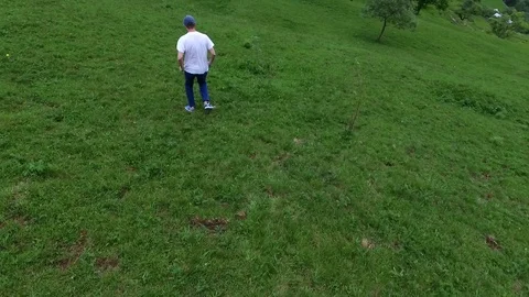 Drone footage of man running down the mountains Stock Footage 118393818