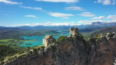 Drone footage of the medieval Samitier Castle and chapel perched on a dramatic Stock Footage 346664941