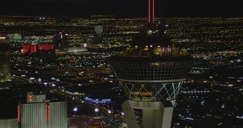 Drone footage moving through Vegas Stratosphere onto buildings, helicopter Stock Footage