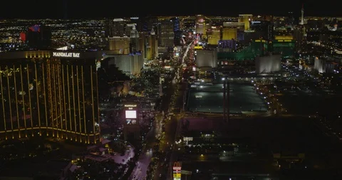 Drone footage moving through Vegas hotels and casinos, helicopter aerial, night Stock Footage