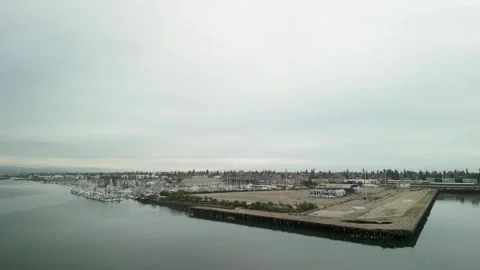 Drone footage over Mariner Square, showcasing an array of docked boats and the Stock Footage 297826309