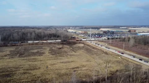 Drone footage over moving train in rural Michigan Video stock 275628686