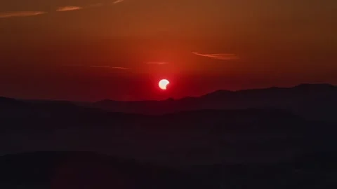 Drone Footage of Partial Solar Eclipse at Sunset Over Mountains Stock Footage 342993302