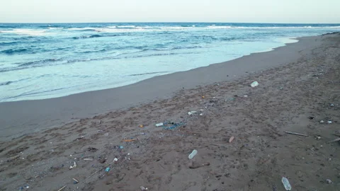 Drone footage of plastic garbage on the seashore. Polluted coastline at sunset Stock Footage 276290751