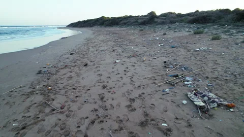 Drone footage of plastic garbage on the seashore. Polluted coastline at sunset Stock Footage 295915132