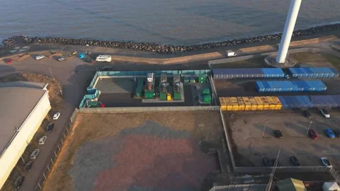 Drone footage pulling away from a BESS system on the Suffolk coast Stock Footage 330795089