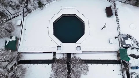 Drone footage pulling in towards the ancient Verinag spring, surrounded by Stock Footage 311129460