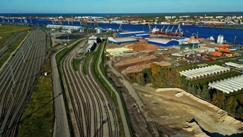 Drone footage of railway yard with multiple tracks running parallel and curving Stock Footage 303955243
