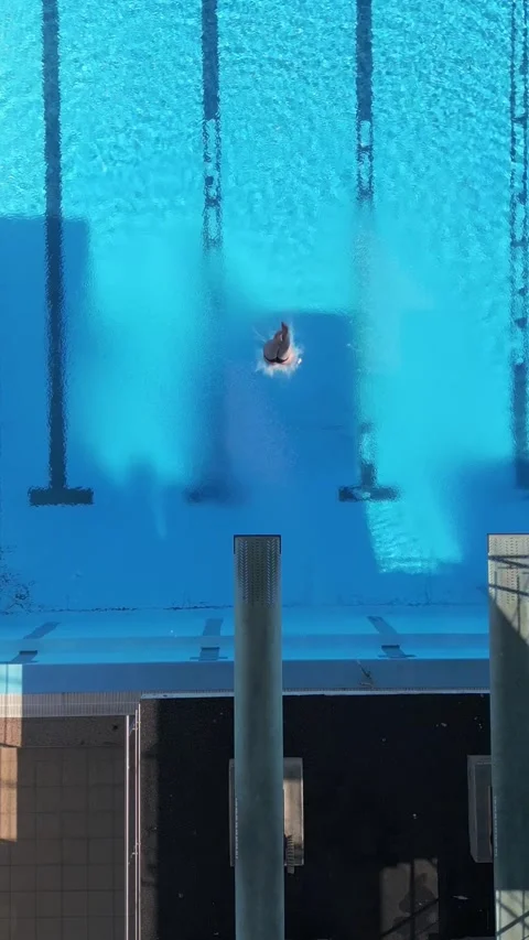 Drone footage in reverse capturing the surreal moment of a diver seemingly Stock Footage 282292981