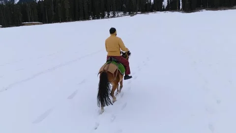 Drone footage of riders creating pathways on untouched snow. Stock Footage 311794616