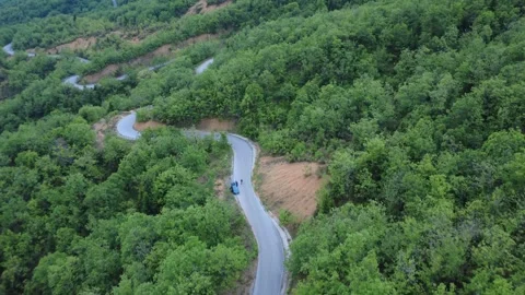 Drone Footage of Rural Road with Sharp Turns and Wild Mediterranean Landscape Stock Footage 312073618