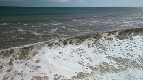 Drone footage of the sea pull back tilt down Stock Footage 247641888