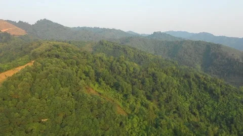 Drone footage showcasing expansive green mountains covered with dense forest in Stock Footage 346665038