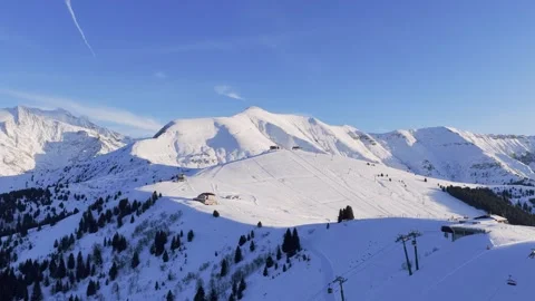Drone footage showcasing the snow-covered slopes of Mont Joly and the Megeve ski Stock Footage 346668673