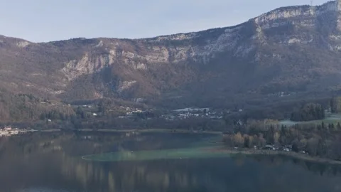Drone footage showcasing the tranquil waters of Lake Aiguebelette, surrounded by Stock Footage 346673951
