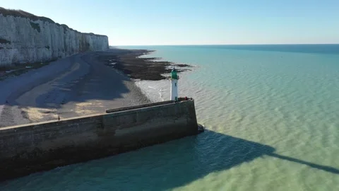 Drone footage showing the iconic lighthouse at the end of a stone pier, with Stock Footage 346669678