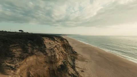Drone footage shows rugged cliffside beach during golden hour Stock Footage 340227059