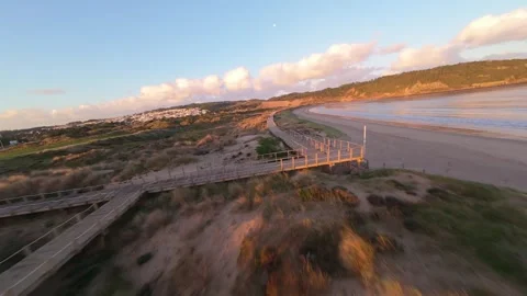 Drone footage shows slow forward motion over beach path Stock Footage 344582780