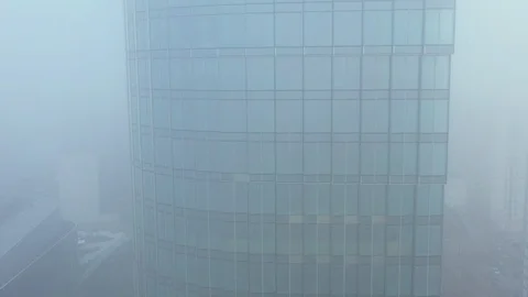 Drone footage of skyscraper in clouds of smog 動画素材 126108159