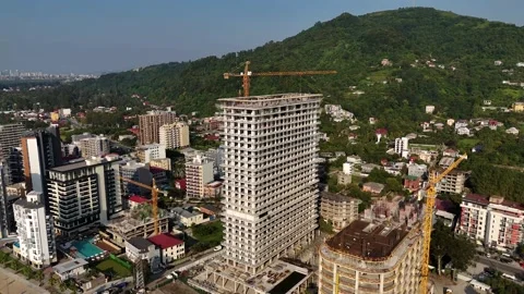 Drone footage of a skyscraper under construction near the seafront  Stock Footage 299298844