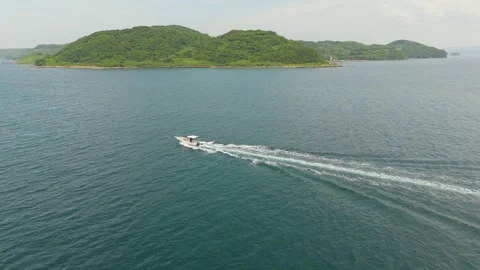 Drone Footage of a Small Boat Sailing Across the Sea Stock Footage 337730845