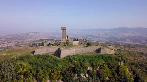 Drone footage of a small medieval building urrounded by fields in Italy (4K) Stock Footage 192467373