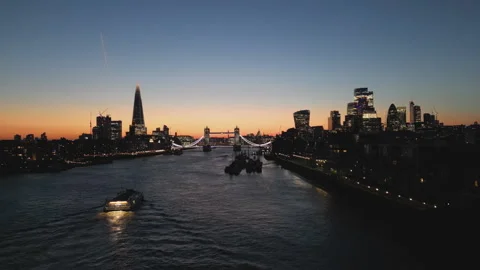 A drone footage of the Thames River and London’s skyscrapers after the sunset. Stock Footage 305729350