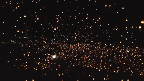 Drone footage of thousands of glowing lanterns flying across screen. Stock Footage 99316488