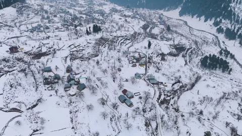 Drone footage of tiny winter shelters dotting the snowfield. Stock Footage 311794571