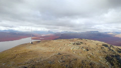 Drone footage from top of a mountain. Circulating shot with people hiking. Stock Footage 212383702