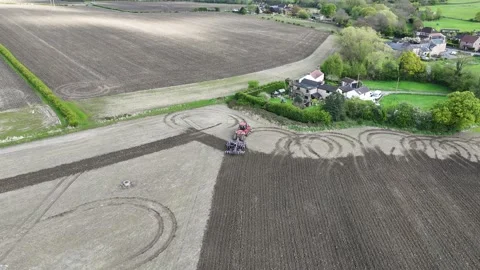 Drone Footage of Tracked Tractor Working Agricultural Fie Stock Footage 324594548