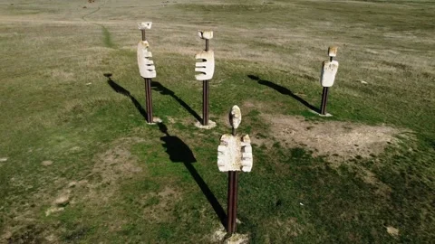 Drone footage of unusual monuments called Human Comedy in a field in Hungary Stock Footage 225677449