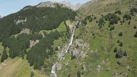 A drone footage of a waterfall stream down the Swiss mountains. Stock Footage 249978123