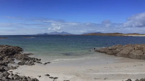 Drone footage of waves lapping up onto rocks in Portuairk Bay, Scotland Stock-Footage 122801823
