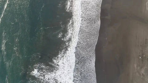 Drone footage of waves lapping at sandy Indonesian shoreline Stock Footage 93781433
