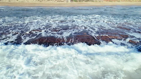 Drone footage of waves, underwater rocks near the shoreline Stock Footage 294307828