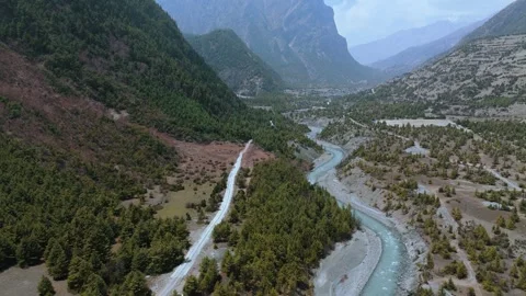 Drone footage of a winding river cutting through the majestic Manang valley. Stock Footage 311018742